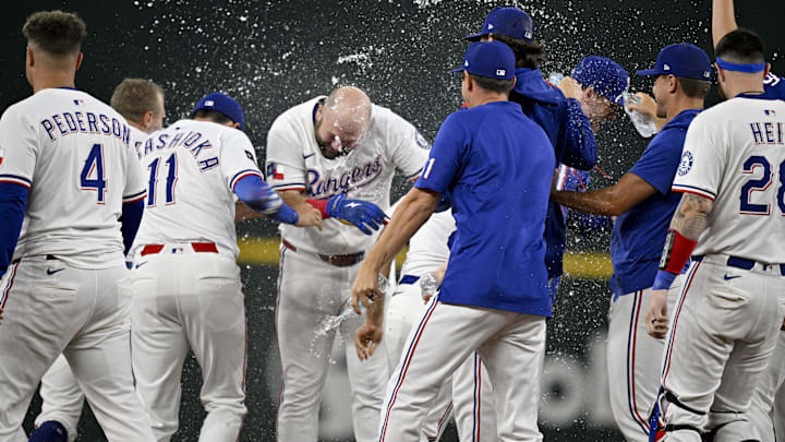 Aug 11, 2025; Arlington, Texas, USA; The Texas Rangers celebrate after pinch hitter Jake Burger (21) drives in the game winning run during the tenth inning at Globe Life Field. 