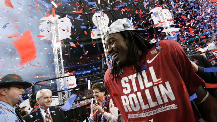 Alabama running back Bo Scarbrough (9) is surrounded by clouds of confetti after Alabama's 24-7 win over Washington in the College Football Playoff semifinal in the Peach Bowl in Atlanta, Saturday December 31, 2016. 