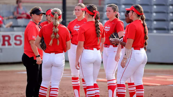Houston softball coach Kristin Vesely (left) talks to her players.