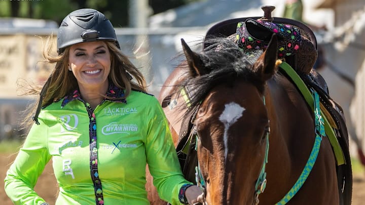 Taylor poses with her bay mare, Puma