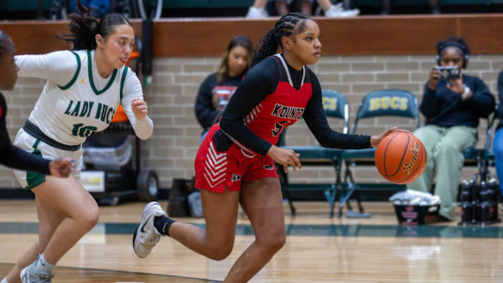 Kountze's Neosha McMahon, right, dribbles in a game against East Chambers on Feb. 6.