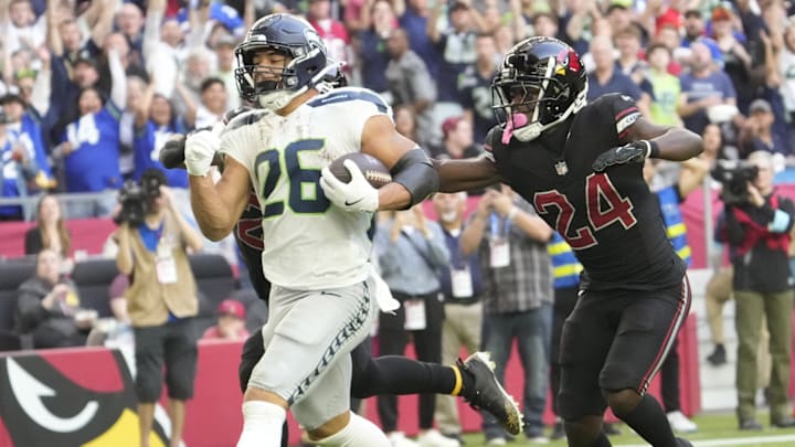Seattle Seahawks running back Zach Charbonnet (26) runs for a touchdown against Arizona Cardinals cornerback Starling Thomas V (24) during the second quarter at State Farm Stadium in Glendale on Dec. 8, 2024.