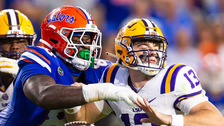 Florida Gators defensive lineman Caleb Banks (88) causes a fumble as he strips the ball from LSU Tigers quarterback Garrett Nussmeier (13) during the second half at Ben Hill Griffin Stadium in Gainesville, FL on Saturday, November 16, 2024. The Gators defeated the Tigers 27-16. [Doug Engle/Gainesville Sun]