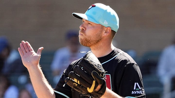 Arizona Diamondbacks pitcher Corbin Burnes reacts after winning the first ABS challenge against the Colorado Rockies in his debut on opening day of spring training season at Salt River Fields at Talking Stick in Scottsdale on Feb. 21, 2025.