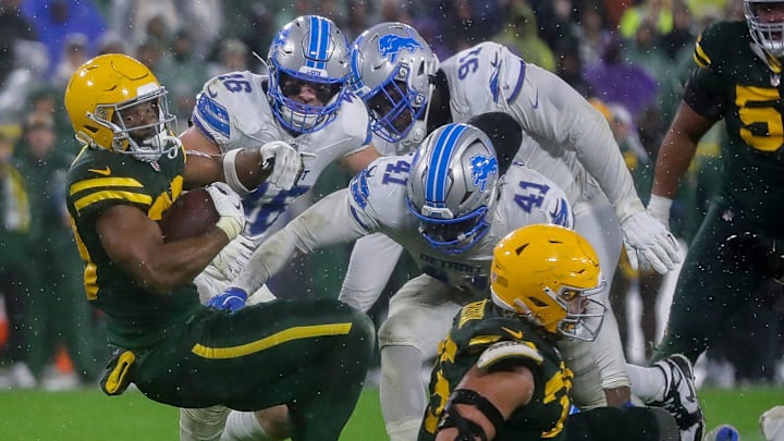 Green Bay Packers running back Chris Brooks (30) falls forward for extra yardage against the Detroit Lions on Sunday.