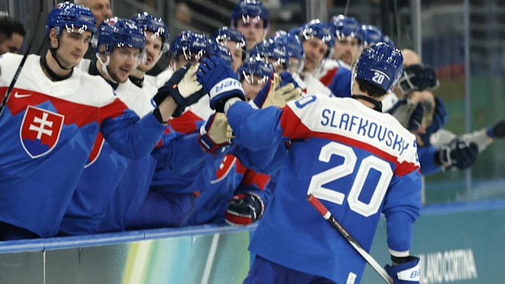 Feb 11, 2026; Milan, Italy;  Juraj Slafkovsky of Slovakia celebrates scoring their third goal with teammates  against Finland in men's ice hockey group B play during the Milano Cortina 2026 Olympic Winter Games at Milano Santagiulia Ice Hockey Arena. Mandatory Credit: Geoff Burke-Imagn Images