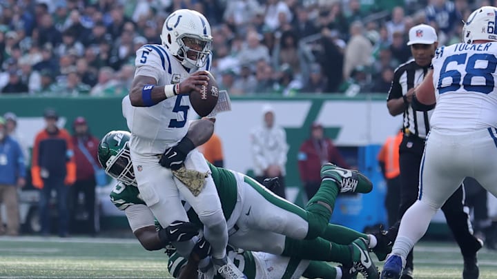 Nov 17, 2024; East Rutherford, New Jersey, USA; Indianapolis Colts quarterback Anthony Richardson (5) is sacked by New York Jets defensive tackle Quinnen Williams (95) and New York Jets linebacker Quincy Williams (56) during the second quarter at MetLife Stadium. 