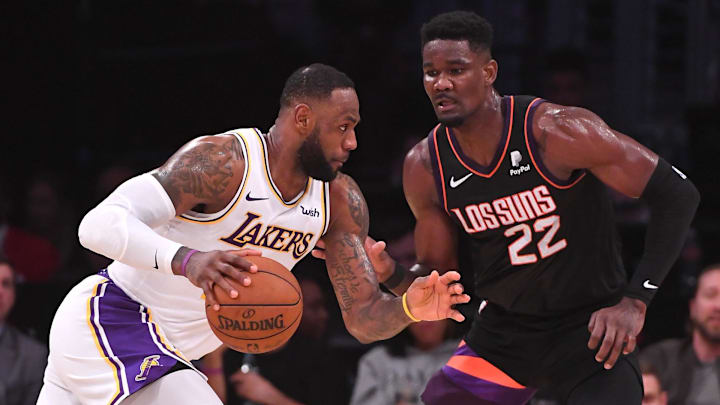 Jan 1, 2020; Los Angeles, California, USA;  Phoenix Suns center Deandre Ayton (22) guards Los Angeles Lakers forward LeBron James (23) in the second half of the game at Staples Center. Mandatory Credit: Jayne Kamin-Oncea-Imagn Images