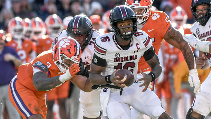 Nov 30, 2024; Clemson, South Carolina, USA; South Carolina quarterback LaNorris Sellers (16) runs away from Clemson defensive end T.J. Parker (3) during the fourth quarter at Memorial Stadium. Mandatory Credit: Ken Ruinard-Imagn Images