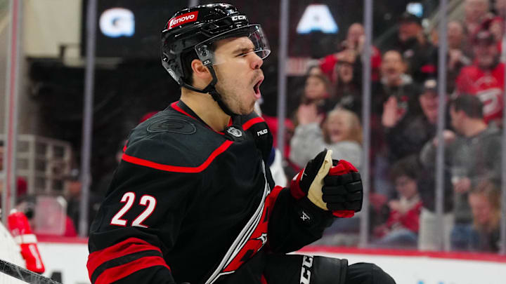 Mar 9, 2025; Raleigh, North Carolina, USA;  Carolina Hurricanes center Logan Stankoven (22) scores a goal against the Winnipeg Jets during the third period at Lenovo Center. Mandatory Credit: James Guillory-Imagn Images