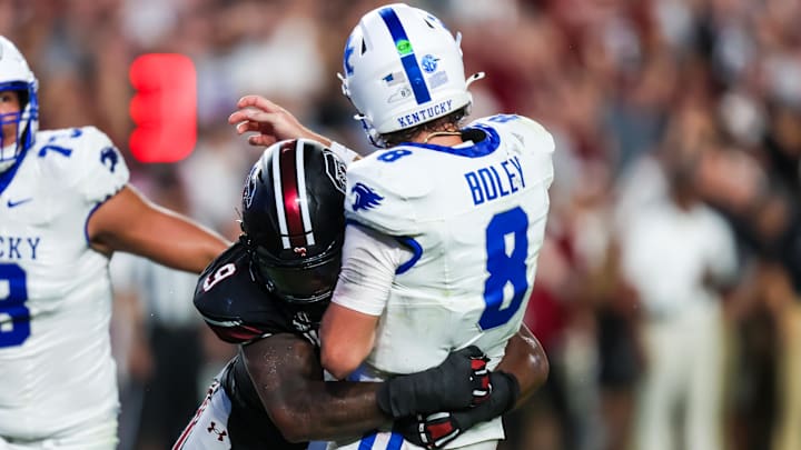 Sep 27, 2025; Columbia, South Carolina, USA; South Carolina Gamecocks linebacker Desmond Umeozulu (9) hits Kentucky Wildcats quarterback Cutter Boley (8) as he passes which causes an interception in the second quarter at Williams-Brice Stadium.