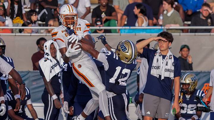 Carol City wide receiver Za'Kari Johnson (9) catches a pass against at West Boca cornerback Dacoby Wooten (12)