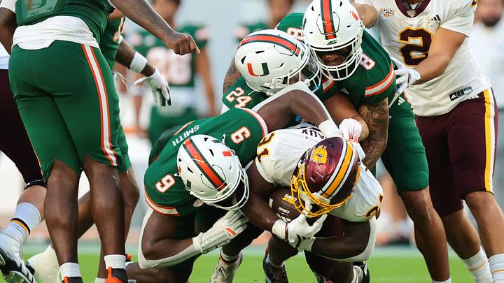 Sep 26, 2026; Miami Gardens, Florida, USA; Miami Hurricanes defensive end Herbert Scroggins III (31) is tackled by Miami Hurricanes linebacker Chase Smith (9), Miami Hurricanes defensive back Ethan O'Connor (24) and Miami Hurricanes defensive lineman Marquise Lightfoot (8) during the first quarter at Hard Rock Stadium. Mandatory Credit: Sam Navarro-Imagn Images Sep 26, 2026; Miami Gardens, Florida, USA; Miami Hurricanes defensive end Herbert Scroggins III (31) is tackled by Miami Hurricanes linebacker Chase Smith (9), Miami Hurricanes defensive back Ethan O'Connor (24) and Miami Hurricanes defensive lineman Marquise Lightfoot (8) during the first quarter at Hard Rock Stadium. Mandatory Credit: Sam Navarro-Imagn Images