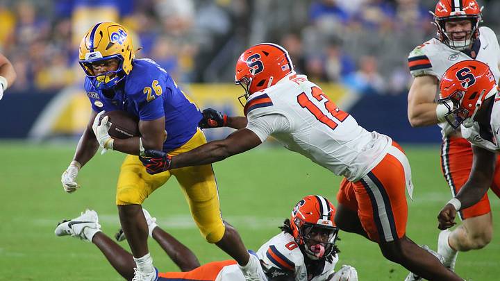 Pittsburgh Panthers running back Damon Ferguson Jr. (26) attempts to slip away from Syracuse Orange defensive back Chris Peal (12) while sprinting downfield during the second half at Acrisure Stadium in Pittsburgh, PA on September 17, 2026. Pittsburgh Panthers running back Damon Ferguson Jr. (26) attempts to slip away from Syracuse Orange defensive back Chris Peal (12) while sprinting downfield during the second half at Acrisure Stadium in Pittsburgh, PA on September 17, 2026.