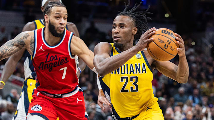 Feb 23, 2025; Indianapolis, Indiana, USA;  Indiana Pacers forward Aaron Nesmith (23) dribbles the ball while LA Clippers guard Amir Coffey (7) defends in the second half at Gainbridge Fieldhouse. Mandatory Credit: Trevor Ruszkowski-Imagn Images