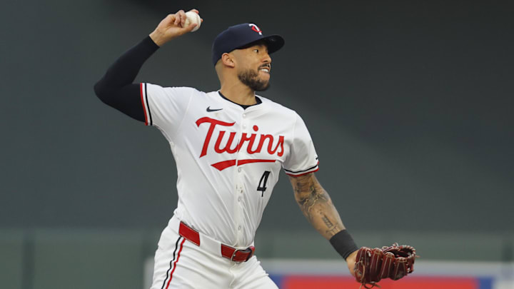 Sep 14, 2024; Minneapolis, Minnesota, USA; Minnesota Twins' Carlos Correa (4) turns a double play against the Cincinnati Reds in the second inning at Target Field.
