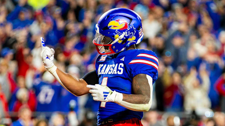 Nov 23, 2024; Kansas City, Missouri, USA;  Kansas running back Devin Neal (4) gestures after scoring a touchdown during the 4th quarter between the Kansas Jayhawks and the Colorado Buffaloes at GEHA Field at Arrowhead Stadium.