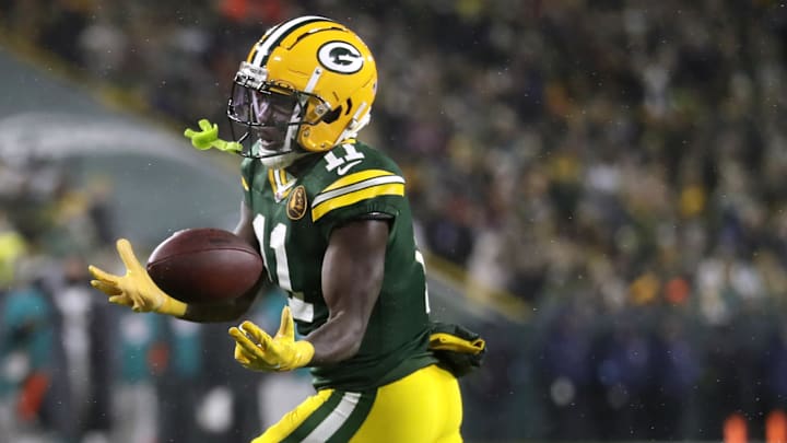 Nov 28, 2024; Green Bay, Wisconsin, USA; Green Bay Packers wide receiver Jayden Reed (11) catches a pass against the Miami Dolphins at Lambeau Field. Mandatory Credit: Wm. Glasheen-Imagn Images
