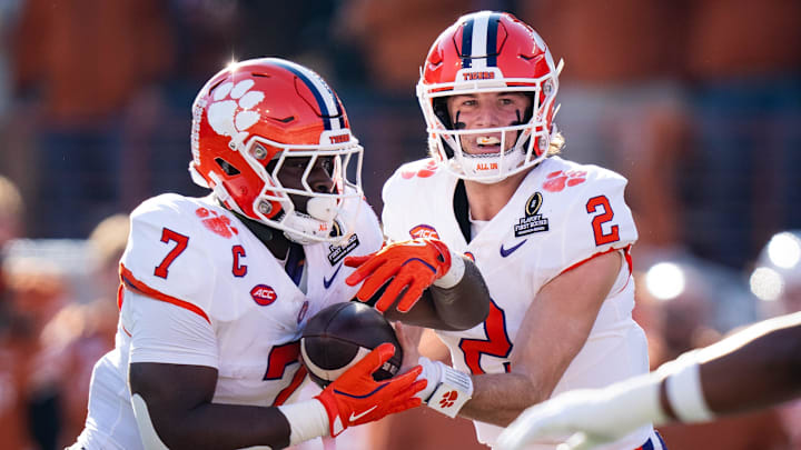 Clemson Tigers quarterback Cade Klubnik (2) hands the ball off to running back Phil Mafah (7) in the first quarter as the Texas Longhorns play the Clemson Tigers in the first round of the College Football Playoffs at Darrell K Royal Texas Memorial Stadium in Austin, Texas, Dec. 21, 2024.