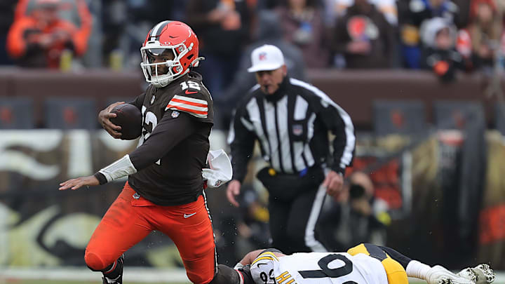 Browns quarterback Shedeur Sanders is tripped up by Pittsburgh Steelers linebacker Alex Highsmith in the second half, Dec. 28, 2025, in Cleveland.