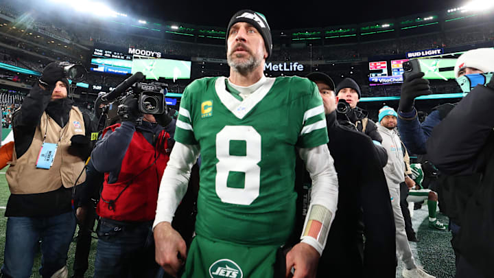 Jan 5, 2025; East Rutherford, New Jersey, USA; New York Jets quarterback Aaron Rodgers (8) walks on the field after the Jets win over the Miami Dolphins at MetLife Stadium. 