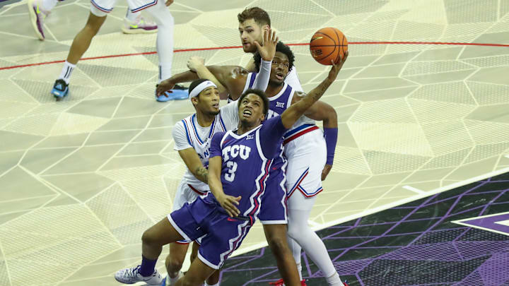 January 22, 2025 matchup between TCU and Kansas, TCU's Vasean Allette is seen driving to the basket against Kansas guard Dajuan Harris Jr. January 22, 2025 matchup between TCU and Kansas, TCU's Vasean Allette is seen driving to the basket against Kansas guard Dajuan Harris Jr.