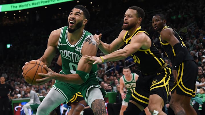 Mar 3, 2024; Boston, Massachusetts, USA;  Boston Celtics forward Jayson Tatum (0) controls the ball while Golden State Warriors guard Stephen Curry (30) defends during the first half at TD Garden. Mandatory Credit: Bob DeChiara-Imagn Images