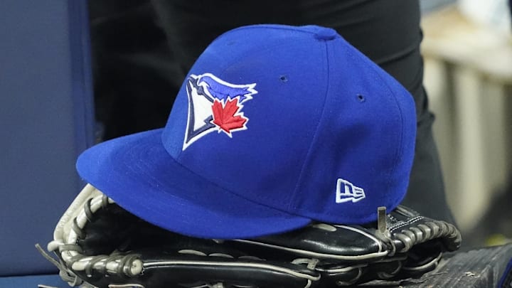Toronto Blue Jays hat and glove in the dugout during the third inning against the Los Angeles Dodgers at Rogers Centre.