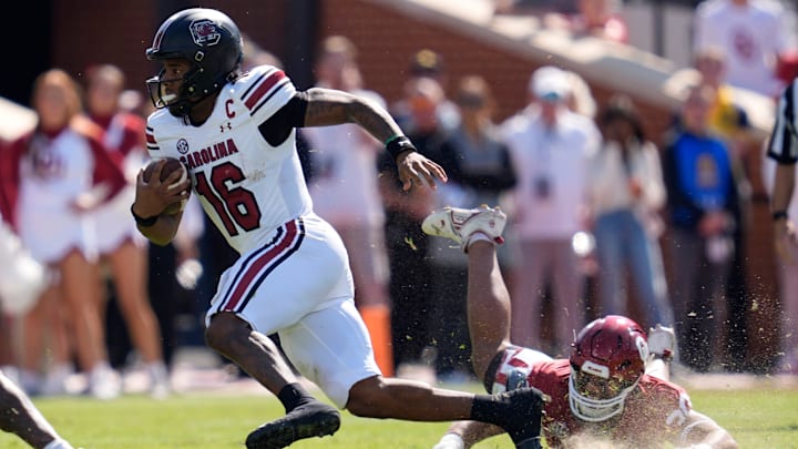 South Carolina Gamecocks quarterback LaNorris Sellers (16) runs past Oklahoma Sooners defensive lineman Trace Ford (30) during a college football game between the University of Oklahoma Sooners (OU) and the South Carolina Gamecocks at Gaylord Family - Oklahoma Memorial Stadium in Norman, Okla., Saturday, Oct. 19, 2024.