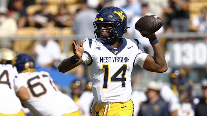 Oct 18, 2025; Orlando, Florida, USA;  West Virginia Mountaineers quarterback Khalil Wilkins (14) makes a pass in the second half against the Central Florida Knights at Acrisure Bounce House. Mandatory Credit: Russell Lansford-Imagn Images