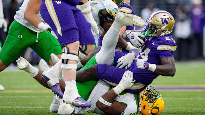 Oregon defensive lineman A'Mauri Washington brings down Washington running back Adam Mohammed as the Oregon Ducks take on the Washington Huskies on Nov. 29, 2025, at Husky Stadium in Seattle, Washington. Oregon defensive lineman A'Mauri Washington brings down Washington running back Adam Mohammed as the Oregon Ducks take on the Washington Huskies on Nov. 29, 2025, at Husky Stadium in Seattle, Washington.