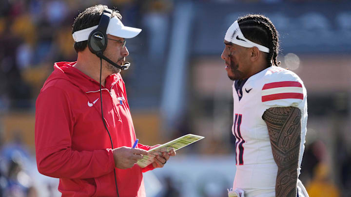 Arizona head coach Jedd Fisch talks with quarterback Noah Fifita (11) during the first quarter