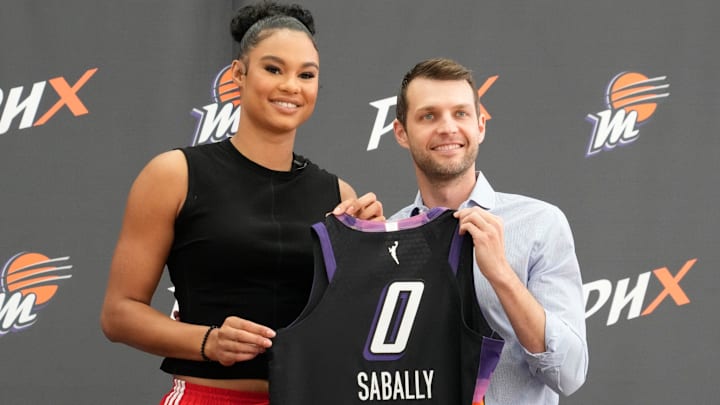 Mercury forward Satou Sabally holds her jersey with general manager Nick U’Ren during a news conference at the Phoenix Mercury Practice Facility. Mercury forward Satou Sabally holds her jersey with general manager Nick U’Ren during a news conference at the Phoenix Mercury Practice Facility.