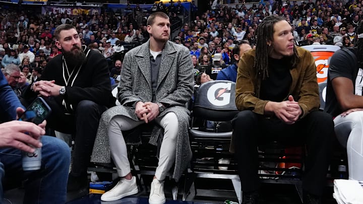 Jan 18, 2026; Denver, Colorado, USA; Denver Nuggets forward Aaron Gordon (32), center Nikola Jokic (15) and center Jonas Valanciunas (17) on the bench in the third quarter against the Charlotte Hornets at Ball Arena. Mandatory Credit: Ron Chenoy-Imagn Images