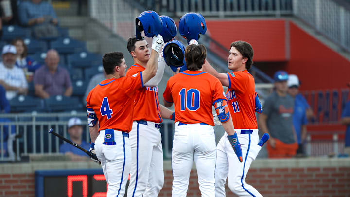 Cade Kurland (4), Luke Heyman (28) and Colby Shelton (10) celebrate with Brendan Lawson (11) after the freshman's three-run home run against Jacksonville. The Florida Gators would go on to win 16-4. Cade Kurland (4), Luke Heyman (28) and Colby Shelton (10) celebrate with Brendan Lawson (11) after the freshman's three-run home run against Jacksonville. The Florida Gators would go on to win 16-4.