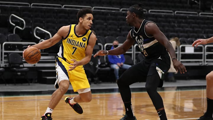 Feb 3, 2021; Milwaukee, WI, USA; Indiana Pacers guard Malcolm Brogdon (7) dribbles against Milwaukee Bucks guard Jrue Holiday (21) at the Bradley Center.  Mandatory Credit: Nick Monroe/Handout Photo via Imagn Images
