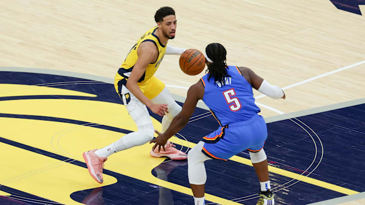 Jun 19, 2025; Indianapolis, Indiana, USA; Indiana Pacers guard Tyrese Haliburton (0) dribbles the ball defended by Oklahoma City Thunder guard Luguentz Dort (5) in the second quarter during game six of the 2025 NBA Finals at Gainbridge Fieldhouse. Mandatory Credit: Trevor Ruszkowski-Imagn Images