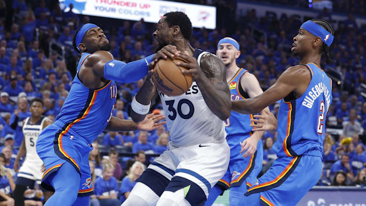 May 22, 2025; Oklahoma City, Oklahoma, USA; Oklahoma City Thunder guard Luguentz Dort (5) knocks the ball away from Minnesota Timberwolves forward Julius Randle (30) in the third quarter during Game 2 of the Western Conference Finals at Paycom Center. Mandatory Credit: Alonzo Adams-Imagn Images