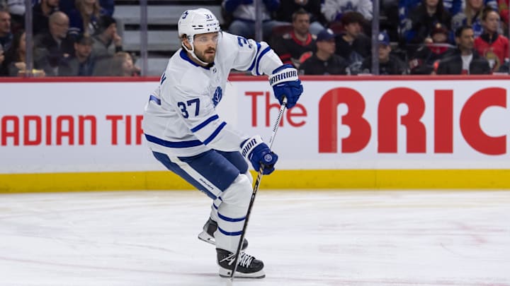 Feb 10, 2024; Ottawa, Ontario, CAN; Toronto Maple Leafs defenseman Timothy Liljegren (37) skates with the puck in the first period against the Ottawa Senators at the Canadian Tire Centre. Mandatory Credit: Marc DesRosiers-Imagn Images