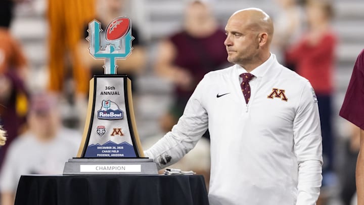 Dec 26, 2025; Phoenix, AZ, USA; Minnesota Gophers head coach P.J. Fleck with the trophy after defeating the New Mexico Lobos in overtime of the Rate Bowl at Chase Field. Mandatory Credit: Mark J. Rebilas-Imagn Images