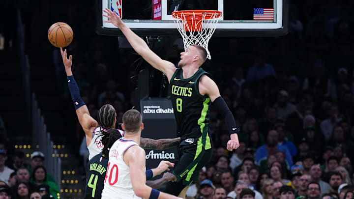 Nov 25, 2024; Boston, Massachusetts, USA; Boston Celtics center Kristaps Porzingis (8) defends against LA Clippers guard Amir Coffey (7) in the first quarter at TD Garden. Mandatory Credit: David Butler II-Imagn Images