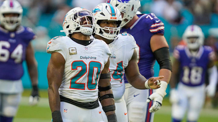  Miami Dolphins linebacker Jordyn Brooks (20) and defensive tackle Jordan Phillips (94) celebrate a fourth down stop against the Buffalo Bills during the fourth quarter at Hard Rock Stadium. 