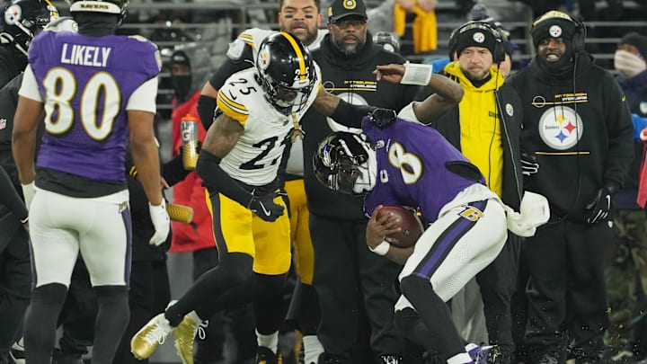 Jan 11, 2025; Baltimore, Maryland, USA; Baltimore Ravens quarterback Lamar Jackson (8) runs the ball against Pittsburgh Steelers safety DeShon Elliott (25) in the first quarter in an AFC wild card game at M&T Bank Stadium. Mandatory Credit: Mitch Stringer-Imagn Images