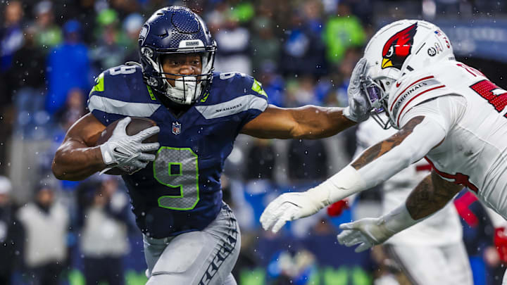Seahawks running back Kenneth Walker III throws a stiff-arm at Xavier Thomas of Arizona. Walker has been rumored as a back who could be traded.
