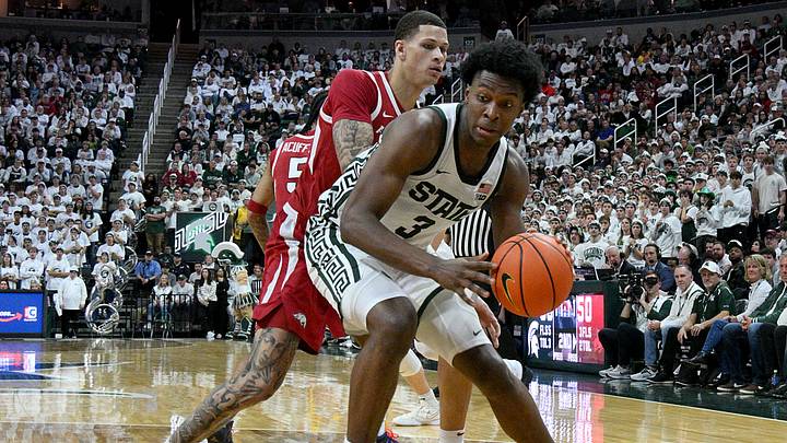 Nov 8, 2025; East Lansing, Michigan, USA;  Michigan State Spartans forward Cameron Ward (3) works the baseline under pressure from Arkansas Razorbacks forward Trevon Brazile (7) during the second half at Jack Breslin Student Events Center. Mandatory Credit: Dale Young-Imagn Images