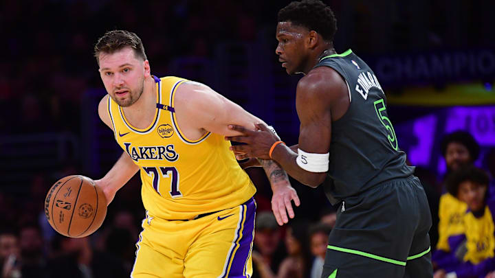 Apr 30, 2025; Los Angeles, California, USA; Los Angeles Lakers guard Luka Doncic (77) controls the ball against Minnesota Timberwolves guard Anthony Edwards (5) during the first half in game five of first round for the 2025 NBA Playoffs at Crypto.com Arena. Mandatory Credit: Gary A. Vasquez-Imagn Images