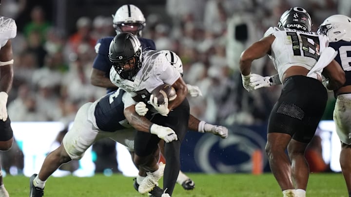 Sep 27, 2025; University Park, Pennsylvania, USA; Oregon Ducks wide receiver Gary Bryant Jr. (2) is tackled by Penn State Nittany Lions linebacker Amare Campbell (24) during the second quarter at Beaver Stadium. Mandatory Credit: James Lang-Imagn Images