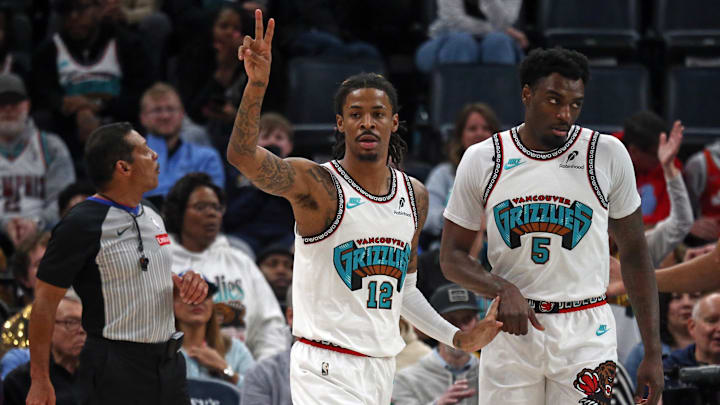 Feb 28, 2025; Memphis, Tennessee, USA; Memphis Grizzlies guard Ja Morant (12) reacts with guard Vince Williams Jr. (5) during the first quarter against the New York Knicks at FedExForum. Mandatory Credit: Petre Thomas-Imagn Images