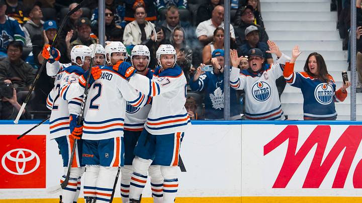 Oct 1, 2026; Vancouver, British Columbia, CAN;  Edmonton Oilers defenseman Evan Bouchard (2) and forwards Connor McDavid (97) and Vasily Podkolzin (92) and Leon Draisaitl (29) celebrate Draisaitl's goal against the Vancouver Canucks in the third period at Rogers Arena.  Mandatory Credit: Bob Frid-Imagn Images