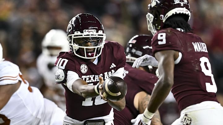 Nov 30, 2024; College Station, Texas, USA; Texas A&M Aggies quarterback Marcel Reed (10) hands off the ball to wide receiver Jahdae Walker (9) during the first half against the Texas Longhorns at Kyle Field. Mandatory Credit: Maria Lysaker-Imagn Images 